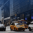 Commercial van and yellow taxi in busy New York City traffic, the kind of driving handled by a CDL traffic ticket lawyer